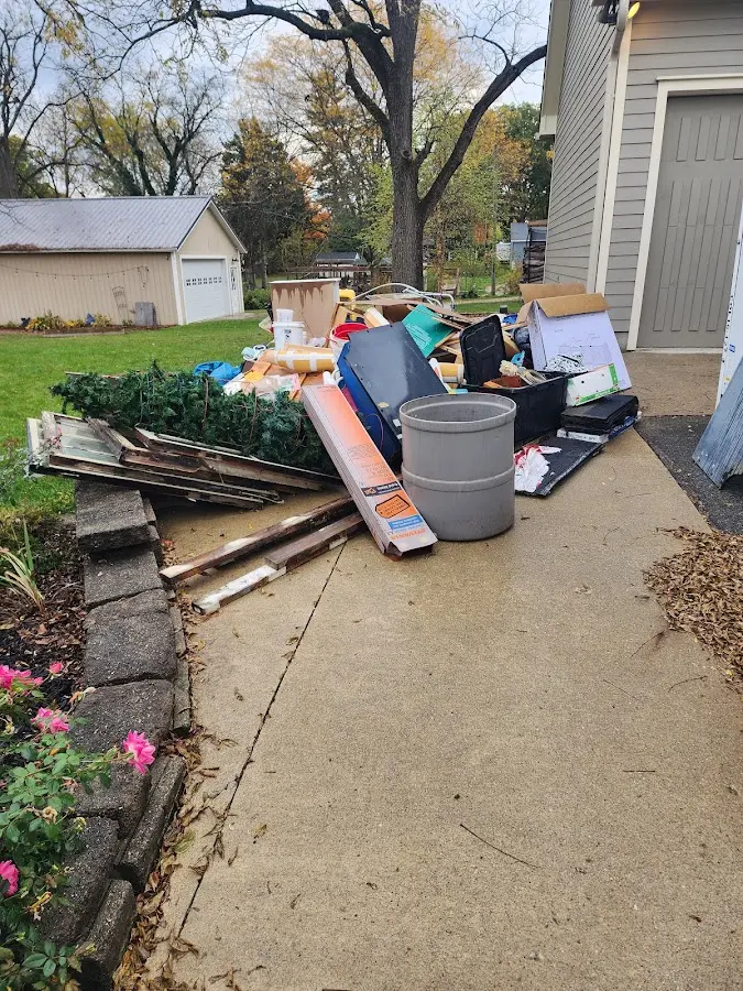 Dumpster being loaded with debris for 12 Yard Dumpster Rental in Isanti
